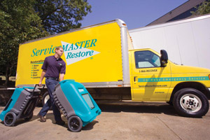 ServiceMaster at Fresno technician bringing dehumidifiers for water damage restoration